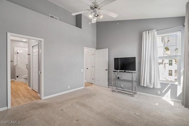 unfurnished living room with light carpet, vaulted ceiling, and ceiling fan