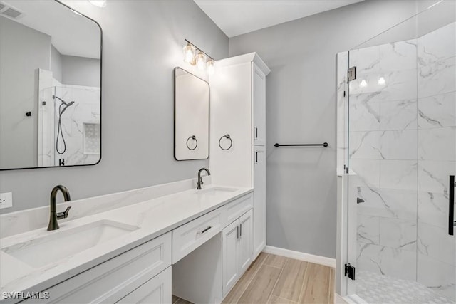 bathroom with vanity, hardwood / wood-style flooring, and a shower with shower door