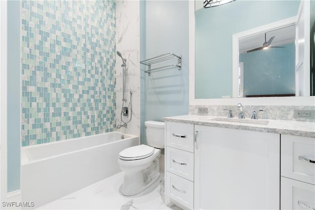 full bathroom featuring ceiling fan, vanity, tiled shower / bath combo, and toilet