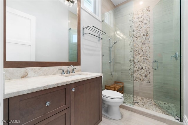 bathroom featuring walk in shower, vanity, and toilet