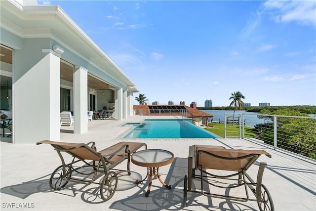 view of swimming pool with a water view and a patio