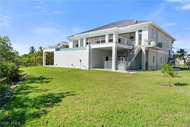 back of house featuring a yard