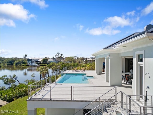 view of swimming pool with a water view and a patio