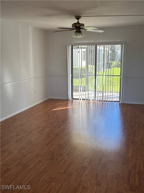 spare room featuring dark hardwood / wood-style floors and ceiling fan