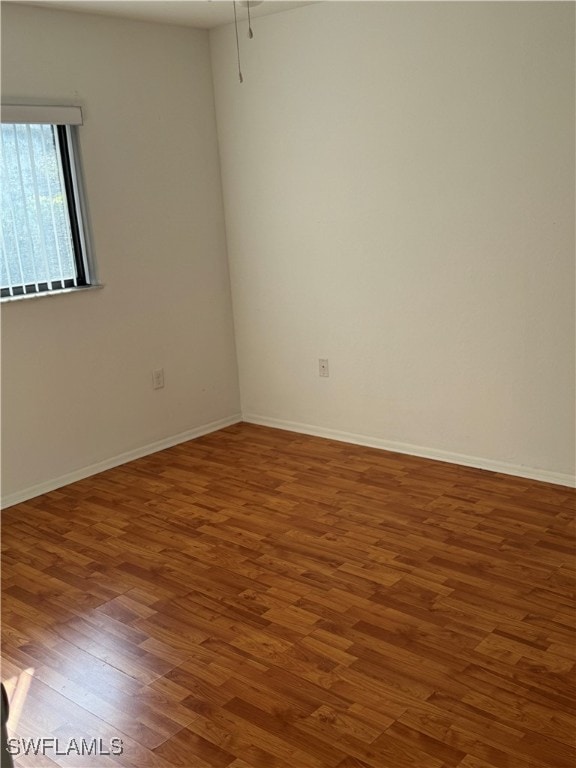 unfurnished room featuring dark wood-type flooring