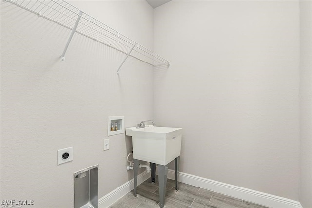 clothes washing area featuring hardwood / wood-style flooring, electric dryer hookup, and hookup for a washing machine