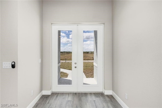 doorway to outside with light hardwood / wood-style flooring and french doors