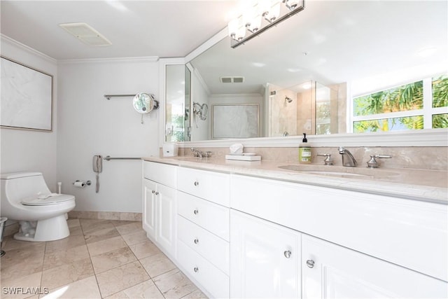 bathroom featuring toilet, vanity, a shower with shower door, and ornamental molding