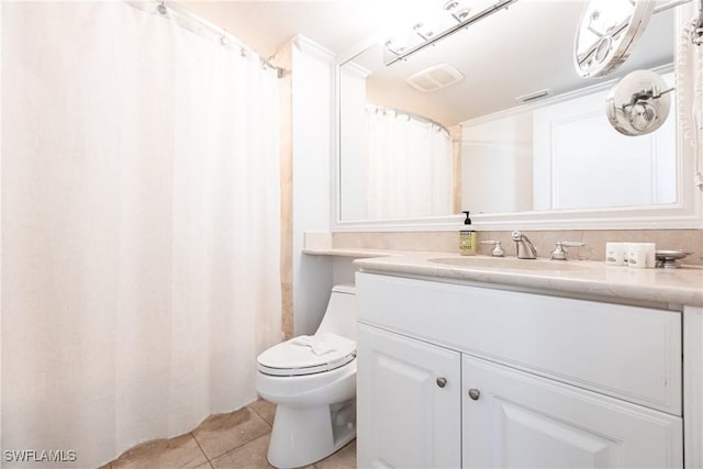 bathroom with tile patterned floors, vanity, and toilet