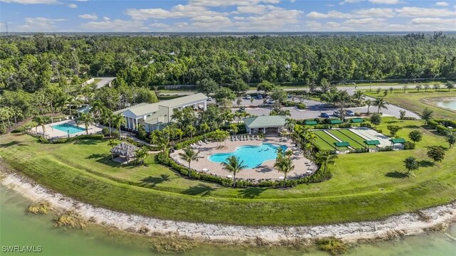 bird's eye view with a water view and a wooded view