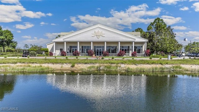 rear view of property with a water view