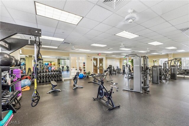 exercise room with french doors, a paneled ceiling, and visible vents