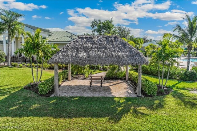 surrounding community with a gazebo, a yard, a patio, and fence