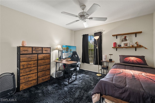 bedroom featuring ceiling fan and dark carpet