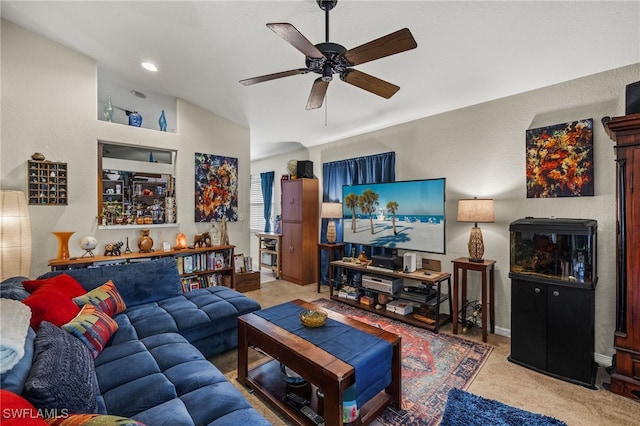 carpeted living room with ceiling fan and built in shelves