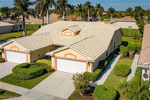 view of front of home with a garage and a front lawn