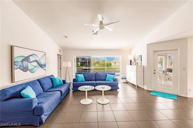 tiled living room featuring ceiling fan and vaulted ceiling