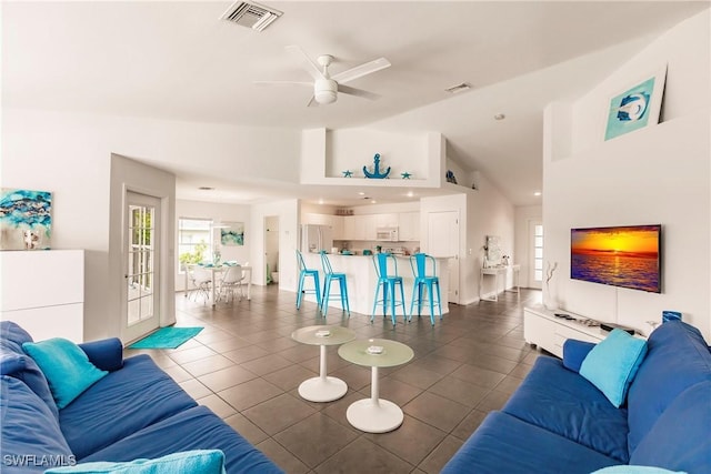 living room with high vaulted ceiling, dark tile patterned flooring, and ceiling fan