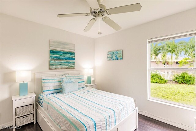 bedroom with ceiling fan and dark hardwood / wood-style floors