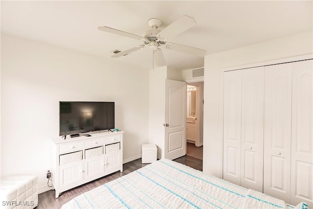 bedroom with ceiling fan, dark hardwood / wood-style floors, and a closet