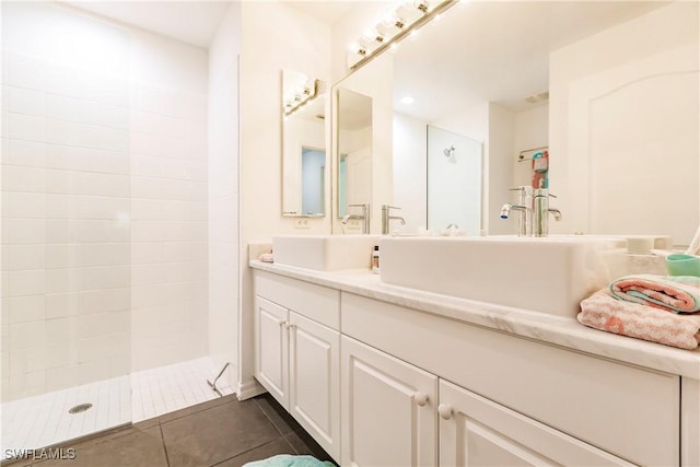 bathroom featuring tile patterned floors, vanity, and walk in shower