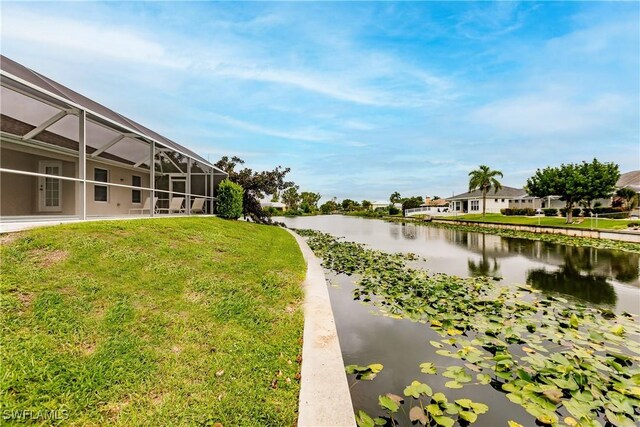 view of community with a yard and a water view