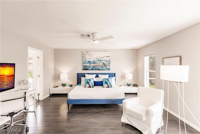 bedroom featuring dark hardwood / wood-style floors, multiple windows, and ceiling fan