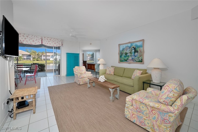 tiled living room with ceiling fan