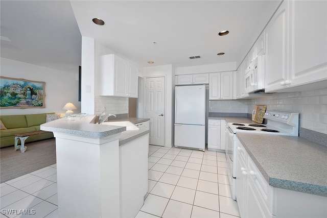 kitchen featuring white cabinets, kitchen peninsula, white appliances, and sink