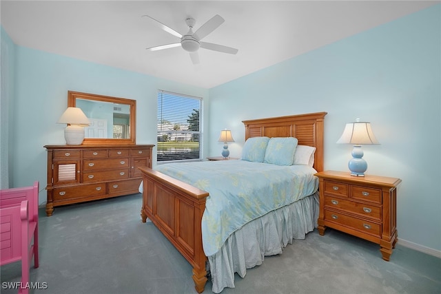 bedroom with dark colored carpet and ceiling fan