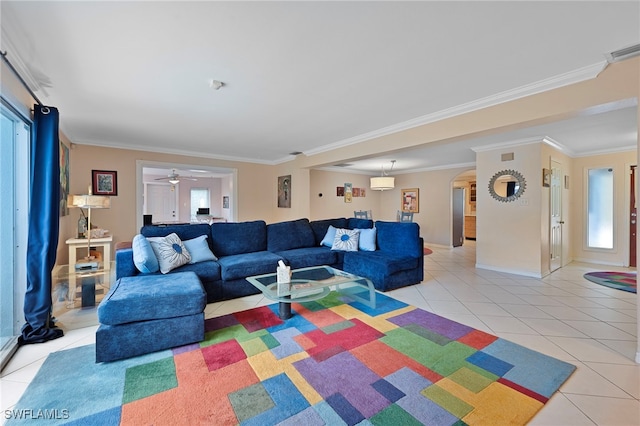 living room featuring light tile patterned floors, visible vents, arched walkways, and ornamental molding