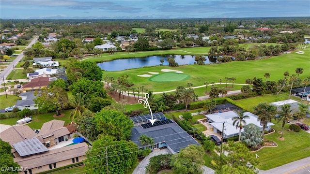 drone / aerial view with a residential view, view of golf course, and a water view