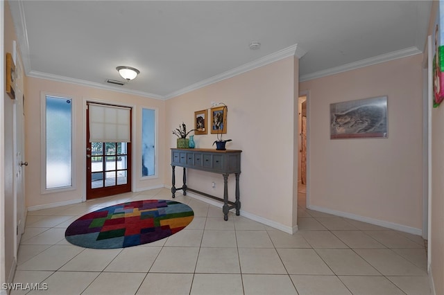 entryway with ornamental molding, light tile patterned flooring, visible vents, and baseboards