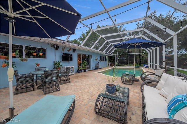 outdoor pool featuring an outdoor hangout area, a patio, and a lanai