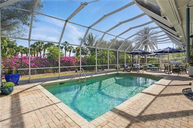pool with a lanai and a patio area