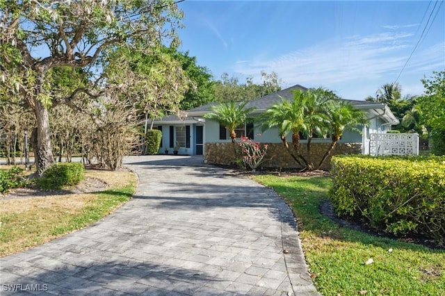 single story home with stucco siding and driveway