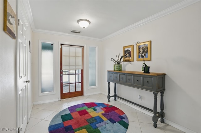 entryway featuring tile patterned floors, visible vents, ornamental molding, and baseboards