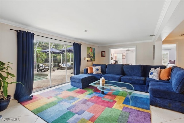 living area featuring crown molding, light tile patterned flooring, and a ceiling fan
