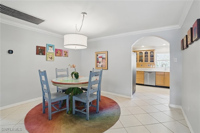 dining room featuring crown molding, arched walkways, light tile patterned floors, and visible vents
