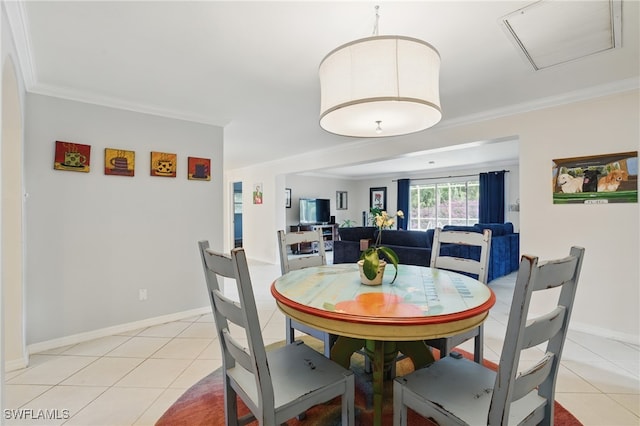 dining room featuring crown molding, baseboards, light tile patterned floors, and visible vents