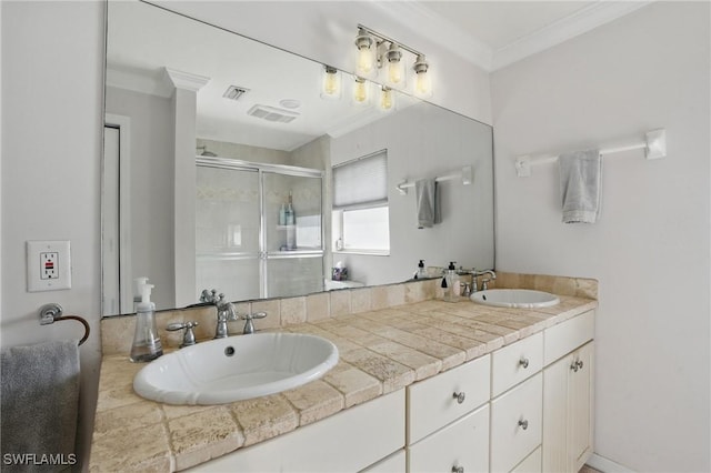 bathroom featuring crown molding, visible vents, a sink, and a stall shower