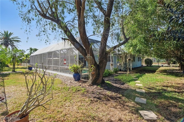 view of yard with glass enclosure