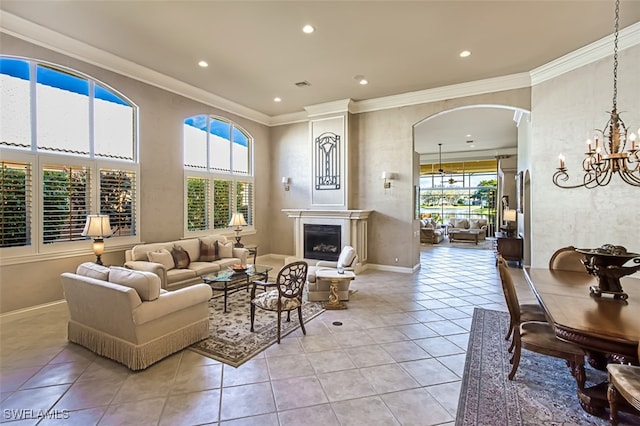 living room with light tile patterned floors, a healthy amount of sunlight, and ornamental molding