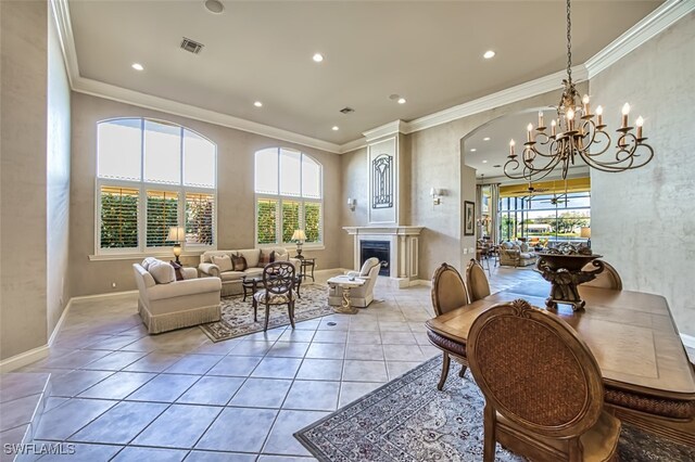 interior space with a chandelier, crown molding, and a healthy amount of sunlight