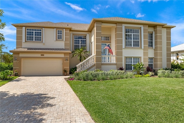 view of front of house featuring a garage and a front lawn