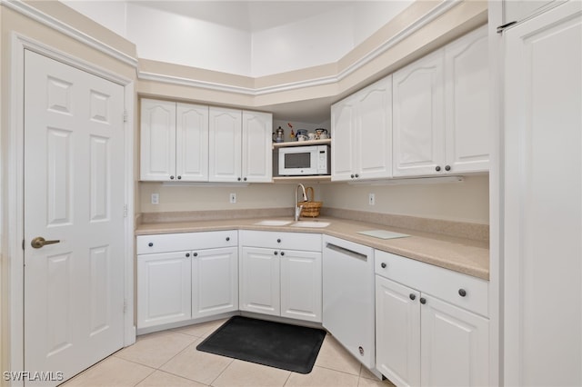 kitchen with white cabinetry, white appliances, sink, and light tile patterned floors