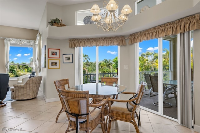 dining area with light tile patterned floors, a wealth of natural light, and a notable chandelier