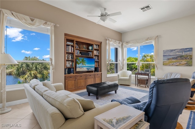 tiled living room featuring ceiling fan