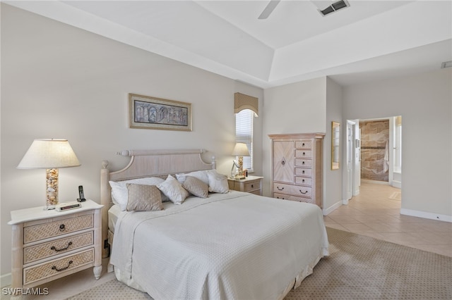 bedroom featuring ensuite bath, ceiling fan, and light tile patterned floors