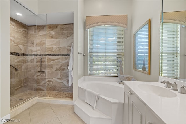 bathroom with tile patterned floors, plenty of natural light, vanity, and independent shower and bath